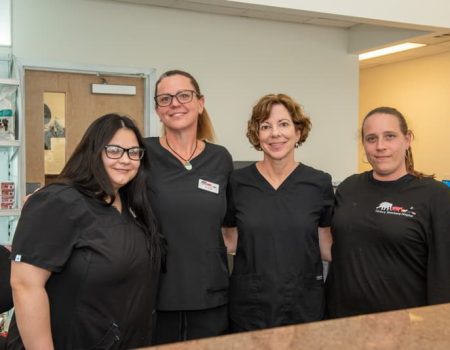 Group of veterinary staff members standing together and smiling