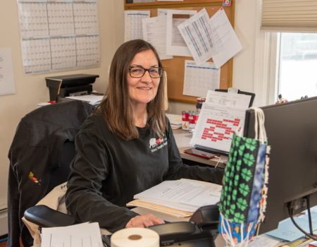 Veterinary staff member reviewing paperwork at a desk